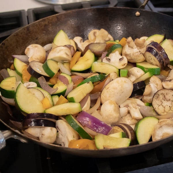 Easy Thai Vegetable Curry with green curry paste and coconut milk. Made with Asian eggplant, baby bok choy, snow peas, mushrooms, zucchini, pepper and more! Serve on jasmine rice. 