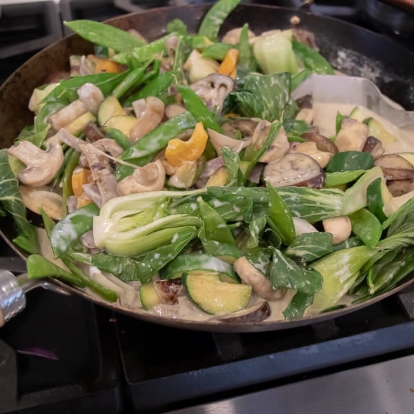 Easy Thai Vegetable Curry with green curry paste and coconut milk. Made with Asian eggplant, baby bok choy, snow peas, mushrooms, zucchini, pepper and more! Serve on jasmine rice. 