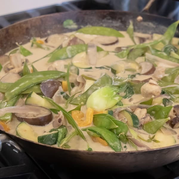 Easy Thai Vegetable Curry with green curry paste and coconut milk. Made with Asian eggplant, baby bok choy, snow peas, mushrooms, zucchini, pepper and more! Serve on jasmine rice. 