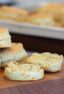 Simple recipe for how to bake cheddar cheese biscuits that are buttery, flakey and simple to make in the oven. Fresh baked and similar to Red Lobster's Cheddar Bay biscuits.