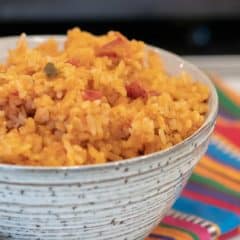 Easy recipe for Mexican rice that is a perfect side dish for a Mexican dinner. Made with rice, salsa & cheese - great in burritos, tacos, fajitas and more.