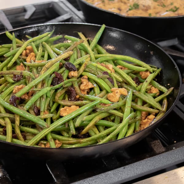 Easy side dish recipe for fresh sautéed green beans with walnuts, dried cherries, lemon zest and lemon juice.