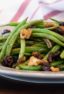 Easy side dish recipe fo fresh sautéed green beans with walnuts, dried cherries, lemon zest and lemon juice.