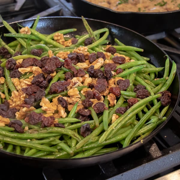 Easy side dish recipe for fresh sautéed green beans with walnuts, dried cherries, lemon zest and lemon juice.