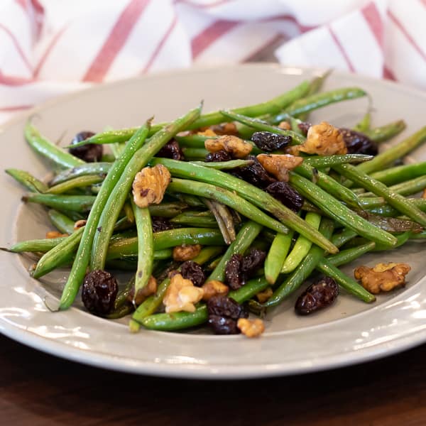 Easy side dish recipe for fresh sautéed green beans with walnuts, dried cherries, lemon zest and lemon juice.