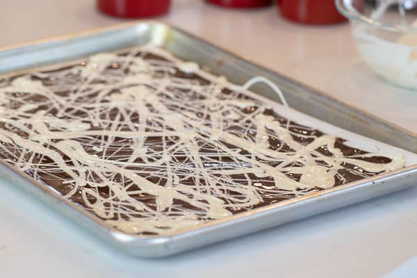 Chocolate bark with a holiday Easter theme. Sweet dessert treat made with dark chocolate melts, white chocolate, malt Easter eggs and sprinkles.