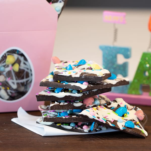 Chocolate bark with a holiday Easter theme. Sweet dessert treat made with dark chocolate melts, white chocolate, malt Easter eggs and sprinkles.