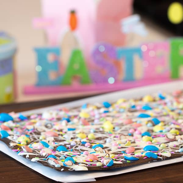 Chocolate bark with a holiday Easter theme. Sweet dessert treat made with dark chocolate melts, white chocolate, malt Easter eggs and sprinkles.