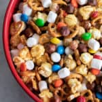 Sweet and salty trail mix recipe made with caramel corn, marshmallows, M&Ms, toasted hazelnuts and mini pretzels. Chocolate, nuts and more, make for a great snack.