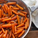 Candied carrots that are made with baby carrots and coated in a glaze with butter, brown sugar, honey and cinnamon. An excellent side dish!