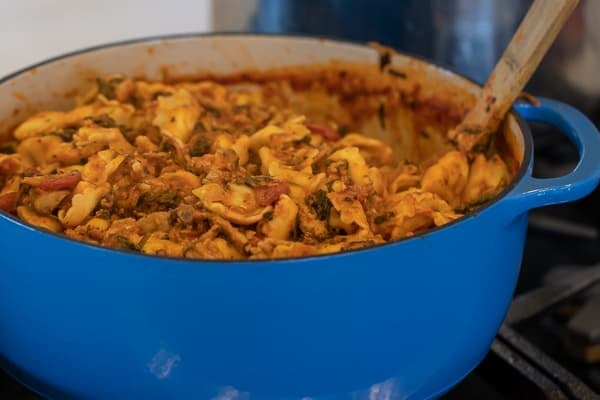 Easy pasta recipe with cheese filled tortellini, ground turkey, zucchini and spinach in a creamy tomato marinara sauce.
