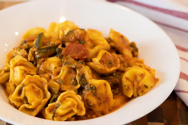 Easy pasta recipe with cheese filled tortellini, ground turkey, zucchini and spinach in a creamy tomato marinara sauce.