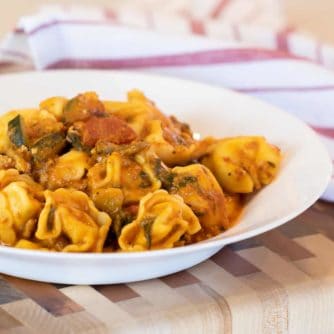 Easy pasta recipe with cheese filled tortellini, ground turkey, zucchini and spinach in a creamy tomato marinara sauce.