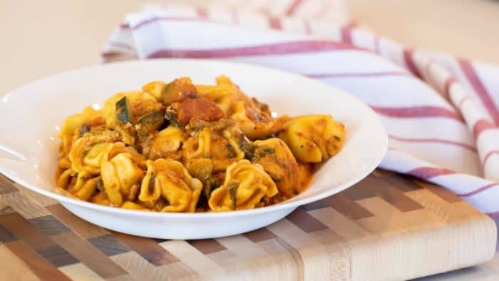 Easy pasta recipe with cheese filled tortellini, ground turkey, zucchini and spinach in a creamy tomato marinara sauce.