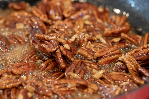 Candied pecans is super easy to make on the stovetop with this recipe. These taste just like praline pecans and made with brown sugar, cinnamon, salt and cayenne.