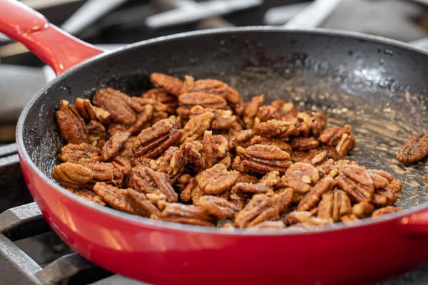 Candied pecans is super easy to make on the stovetop with this recipe. These taste just like praline pecans and made with brown sugar, cinnamon, salt and cayenne.