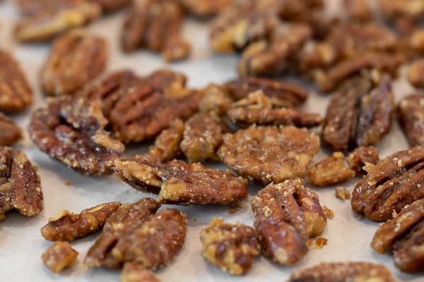 Candied pecans is super easy to make on the stovetop with this recipe. These taste just like praline pecans and made with brown sugar, cinnamon, salt and cayenne.