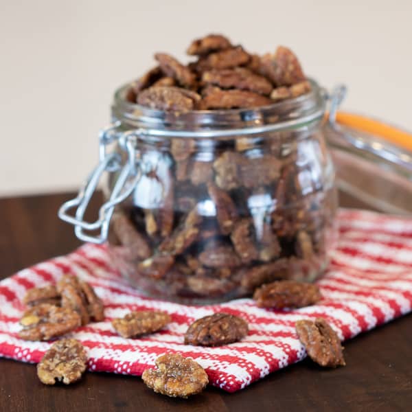 Candied pecans is super easy to make on the stovetop with this recipe. These taste just like praline pecans and made with brown sugar, cinnamon, salt and cayenne.