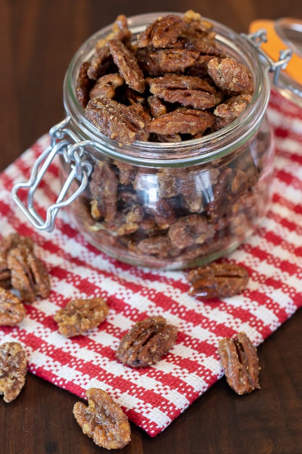 Candied pecans is super easy to make on the stovetop with this recipe. These taste just like praline pecans and made with brown sugar, cinnamon, salt and cayenne.