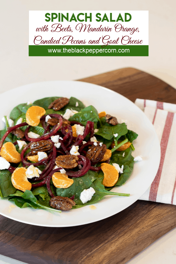 Fresh and healthy salad recipe made with baby spinach, spiralled beets, mandarin oranges, candied pecans and crumbled goat cheese with a honey dijon vinaigrette.