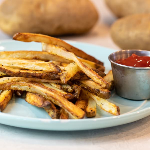 Easy instructions for how to make french fries in an air fryer. Crispy and tastes just like deep fried but this recipe uses very little oil. Russet potatoes make the perfect french fries.