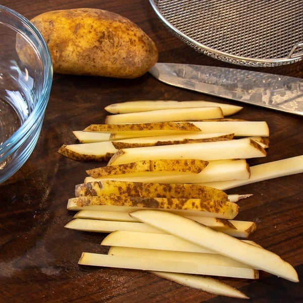 Easy instructions for how to make french fries in an air fryer. Crispy and tastes just like deep fried but this recipe uses very little oil. Russet potatoes make the perfect french fries.