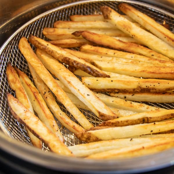 Easy instructions for how to make french fries in an air fryer. Crispy and tastes just like deep fried but this recipe uses very little oil. Russet potatoes make the perfect french fries.