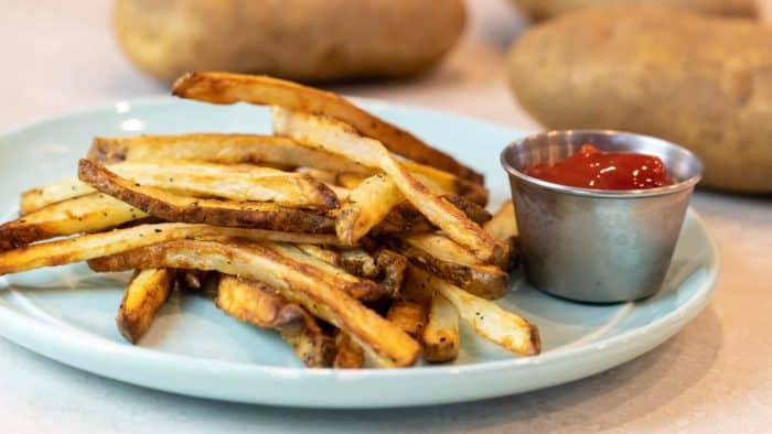 Easy instructions for how to make french fries in an air fryer. Crispy and tastes just like deep fried but this recipe uses very little oil. Russet potatoes make the perfect french fries.