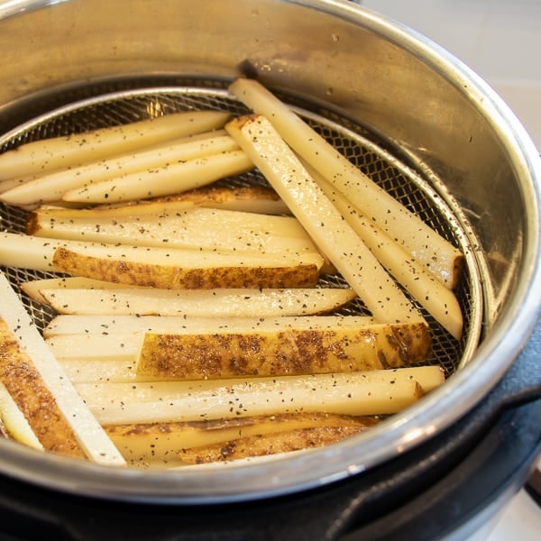 Easy instructions for how to make french fries in an air fryer. Crispy and tastes just like deep fried but this recipe uses very little oil. Russet potatoes make the perfect french fries.