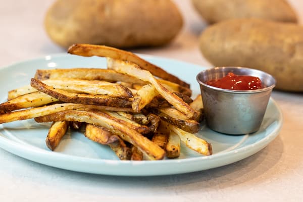 Easy instructions for how to make french fries in an air fryer. Crispy and tastes just like deep fried but this recipe uses very little oil. Russet potatoes make the perfect french fries.