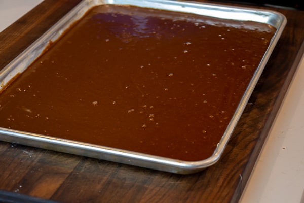 Easy Texas sheet cake recipe made in a 18x13 half sheet pan. Thin layer chocolate cake with fudge like icing. Moist cake made with butter, cocoa, sour cream.