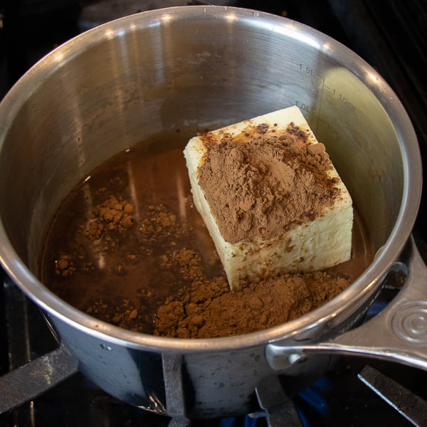 Easy Texas sheet cake recipe made in a 18x13 half sheet pan. Thin layer chocolate cake with fudge like icing. Moist cake made with butter, cocoa, sour cream.