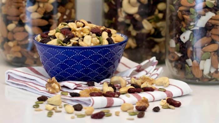 Make your own trail mix at home with a healthy mixture of ingredients. Dried cranberries, raisins, walnuts, cashews, peanuts, pepitas (pumpkin seeds) and sunflower seeds.