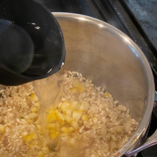 Easy instructions for how to make risotto at home so that it is creamy and tastes just like a restaurant. Made with arborio rice, parmesan cheese, lemon, broth and more.