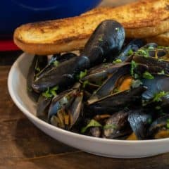 Steamed mussels recipe with white wine, shallots, garlic and butter. The best mussels could not be easier to make at home with this simple and delicious recipe.