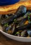 Steamed mussels recipe with white wine, shallots, garlic and butter. The best mussels could not be easier to make at home with this simple and delicious recipe.