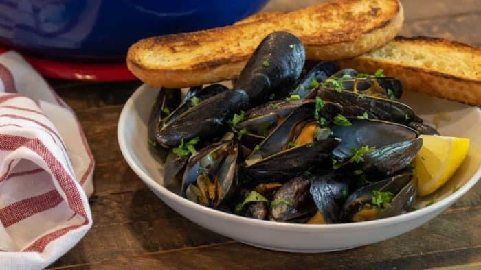 Steamed mussels recipe with white wine, shallots, garlic and butter. The best mussels could not be easier to make at home with this simple and delicious recipe.