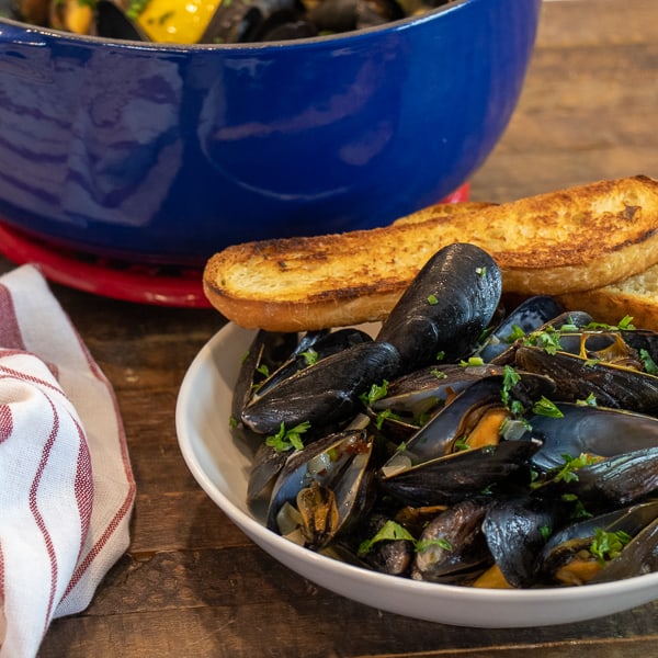 Steamed mussels recipe with white wine, shallots, garlic and butter. The best mussels could not be easier to make at home with this simple and delicious recipe.