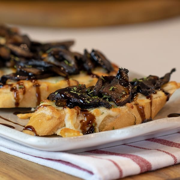 This unique bruschetta has toasted baguettes with melted mozzarella and parmesan. Topped with sautÃ©ed portobello mushrooms and drizzled with balsamic glaze.