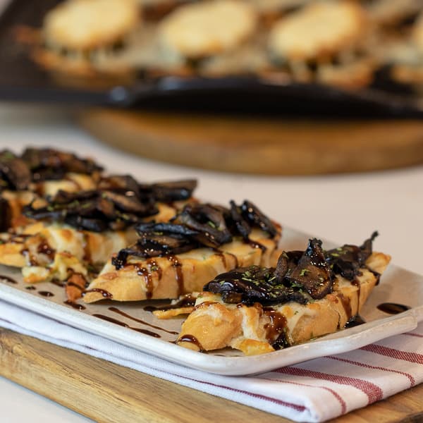 This unique bruschetta has toasted baguettes with melted mozzarella and parmesan. Topped with sautÃ©ed portobello mushrooms and drizzled with balsamic glaze.