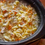 Super simple directions for homemade chicken noodle soup made in a slow cooker. Perfect for leftover chicken with carrots, onion, celery and egg noodles. 