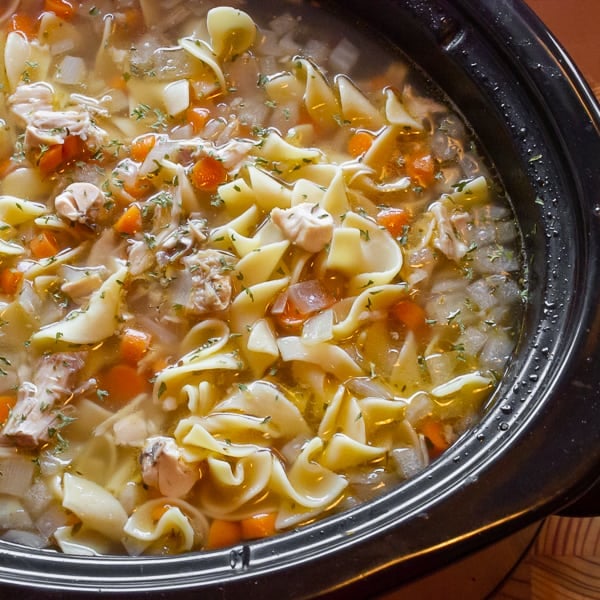 Super simple directions for homemade chicken noodle soup made in a slow cooker. Perfect for leftover chicken with carrots, onion, celery and egg noodles.Â 