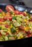 Easy skillet recipe for how to make succotash with lima beans, bacon, corn, okra, grape tomatoes. Classic southern side dish comfort food.