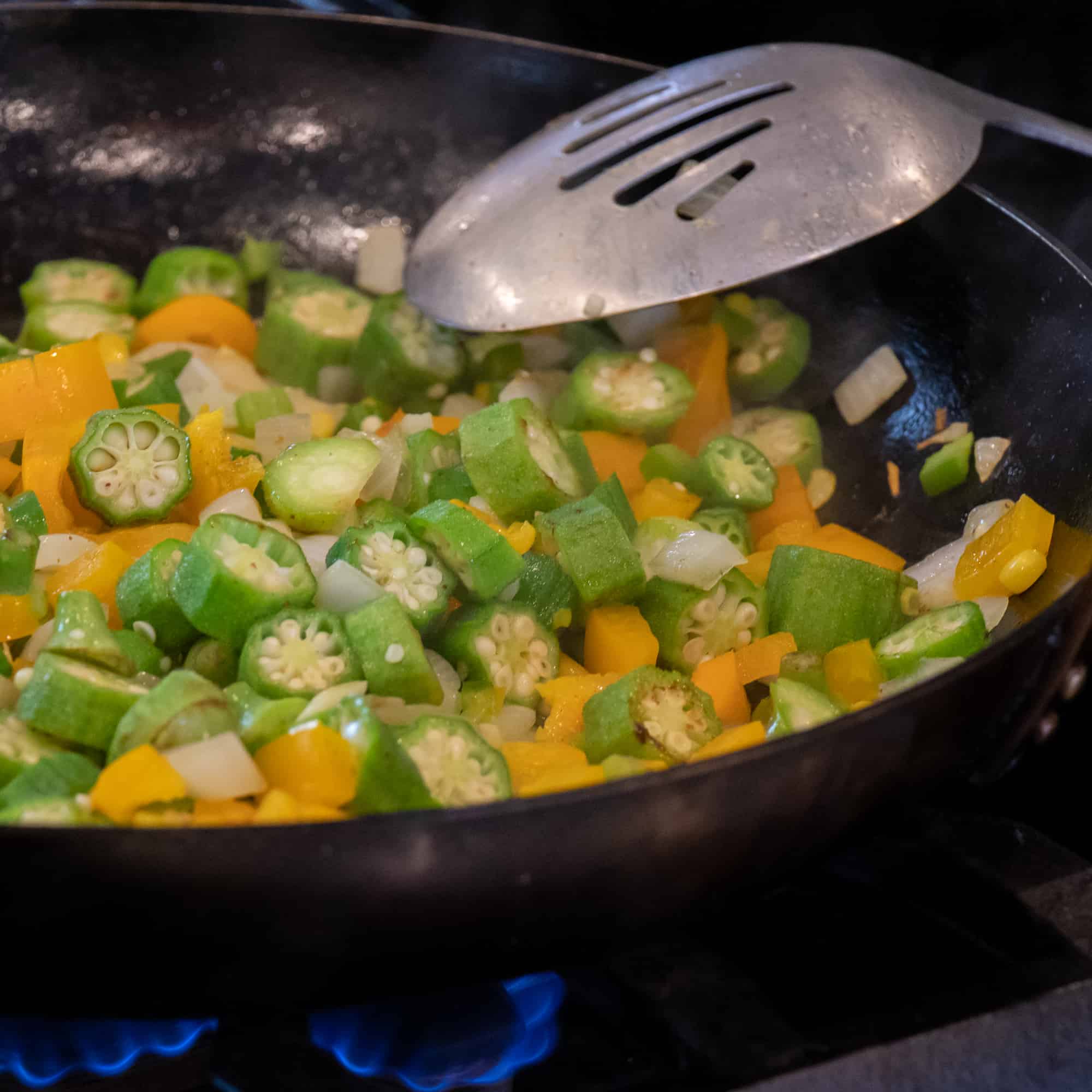 Easy skillet recipe for how to make succotash with lima beans, bacon, corn, okra, grape tomatoes. Classic southern side dish comfort food.