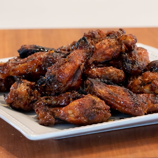 Simple instructions for how to smoke chicken wings with a delicious rub and a sweet and sticky Thai chili glaze.