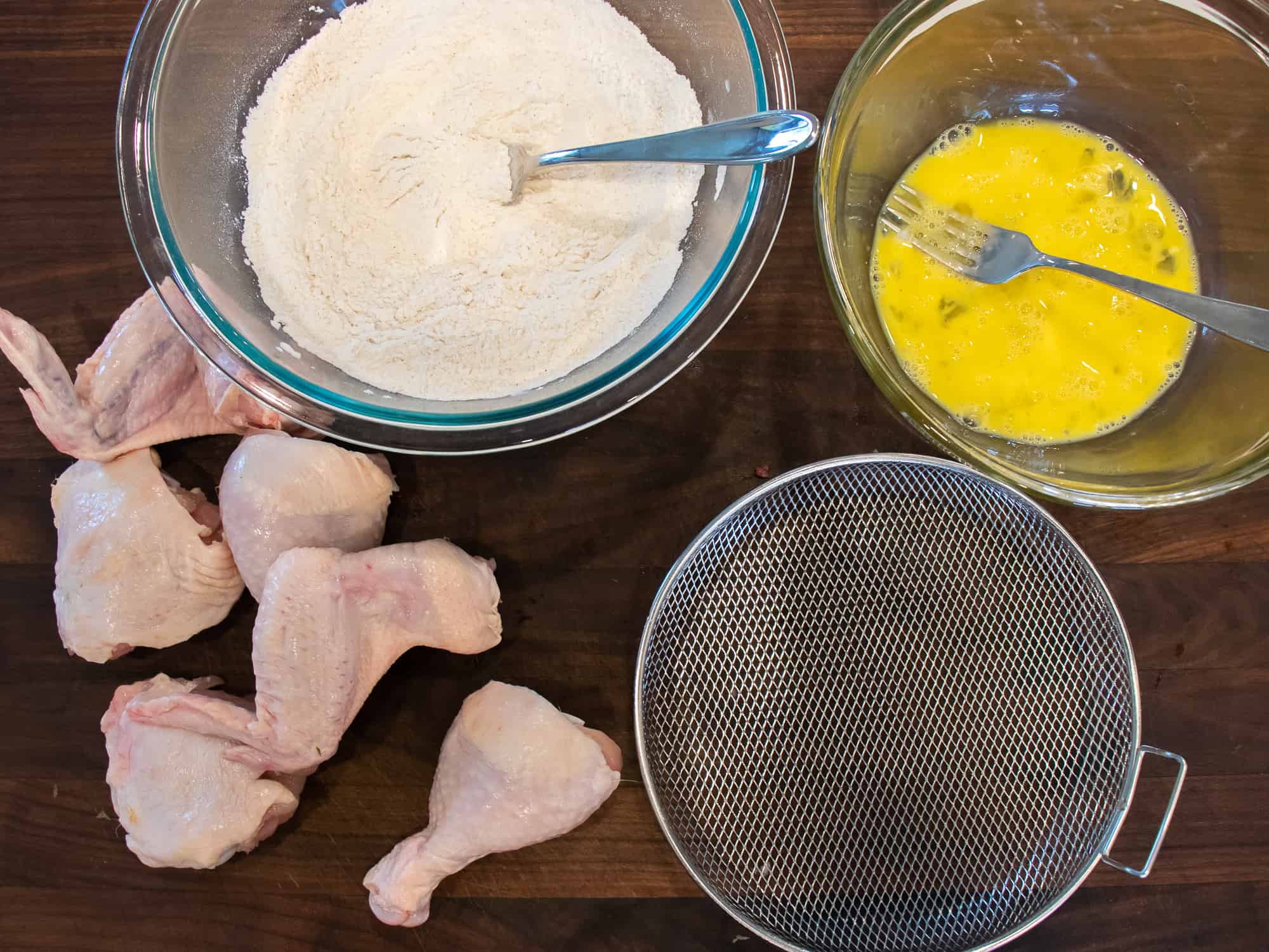 Cut up a whole chicken and dredge in flour and dip in an egg wash.