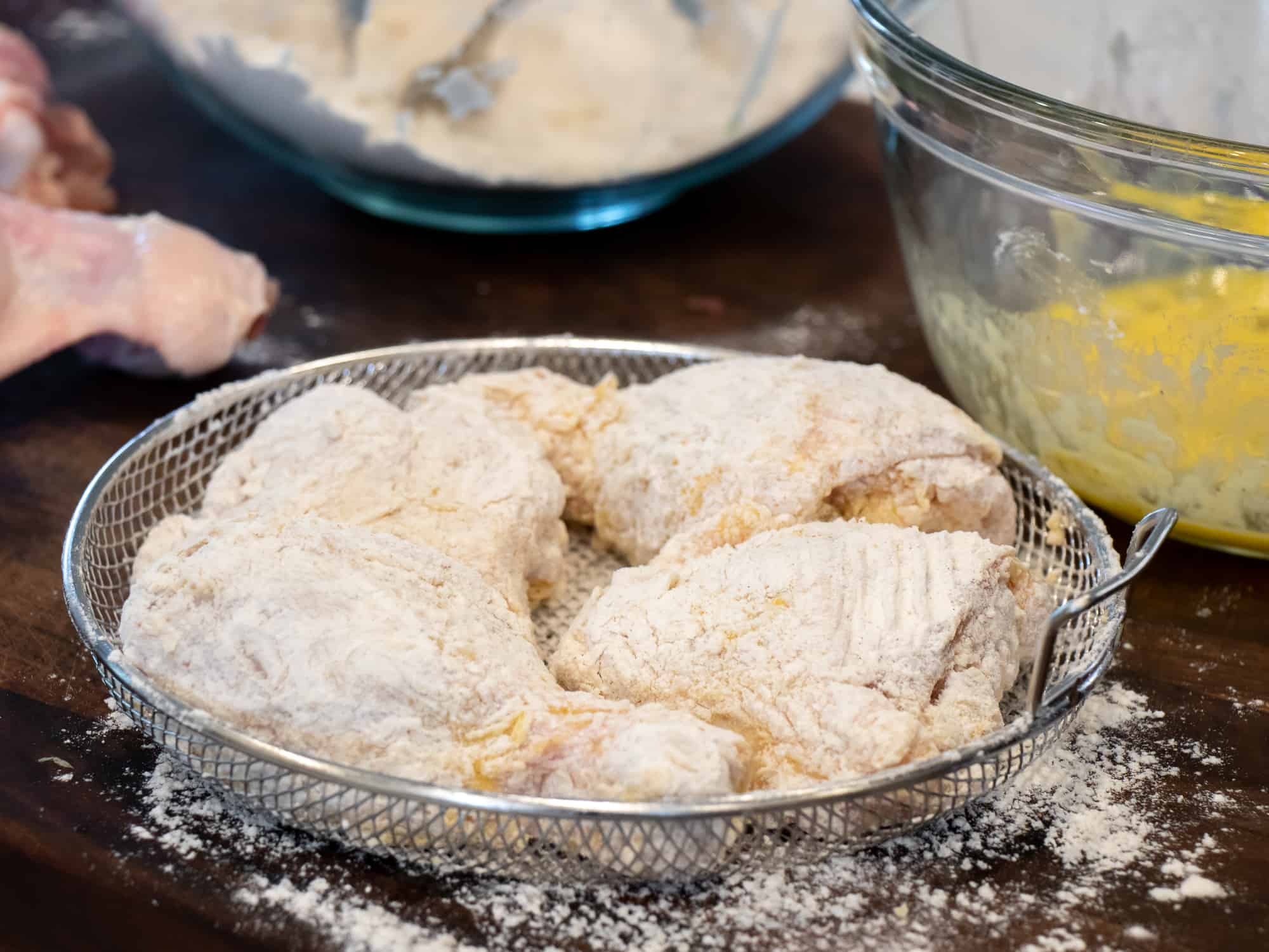 Cut up a whole chicken and dredge in flour and dip in an egg wash.