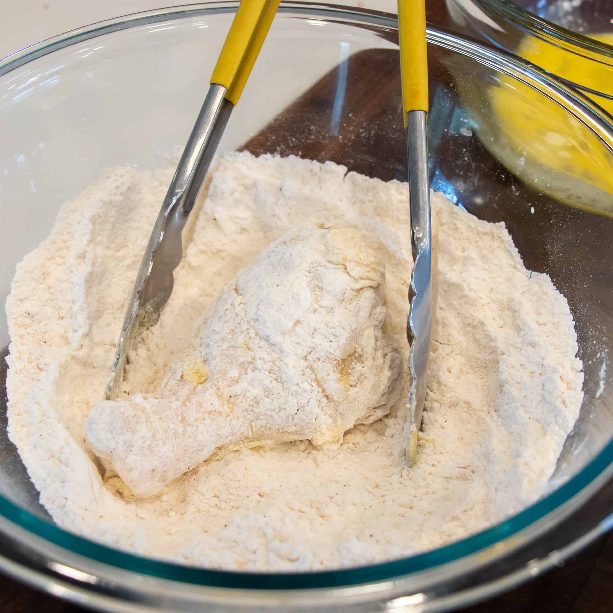 Cut up a whole chicken and dredge in flour and dip in an egg wash.