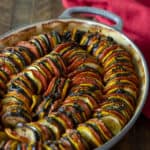 This oven baked ratatouille recipe is a classic French Tian side dish. Made with tomatoes, eggplant, green and yellow zucchini, this is a hearty fall meal.