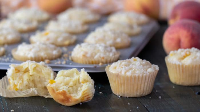 An easy recipe for peach cobbler muffins that is simple and delicious. Fresh Ontario peaches in a light fluffy muffin with a buttery crumble topping.